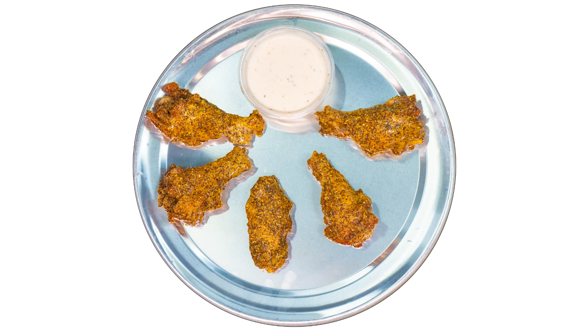 Lemon pepper chicken wings seasoned with cracked black pepper